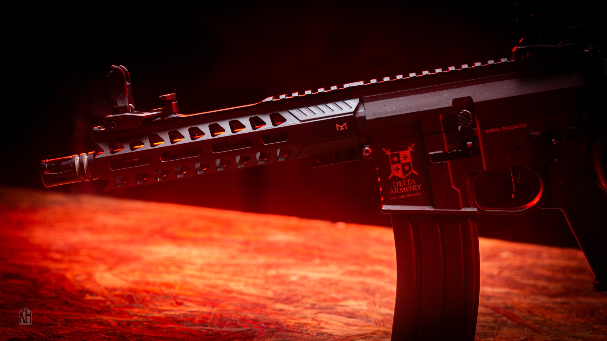 Standard M4-style airsoft hire rifle under red lighting